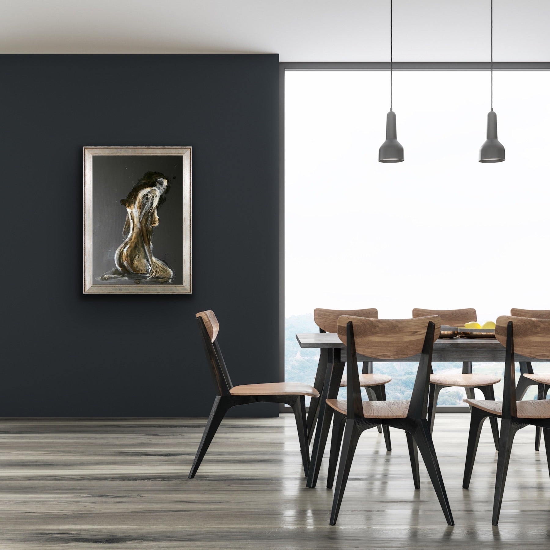 A framed artwork depicting a figure in solitude, placed on a wall above a modern dining table with chairs in a minimalist interior.