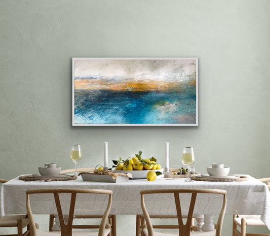 An abstract oil on linen painting displayed above a dining table with white tablecloth and wooden chairs, depicting serene water-like textures in blue and white colors.  The artwork is featured in Windsor Gallery's collection